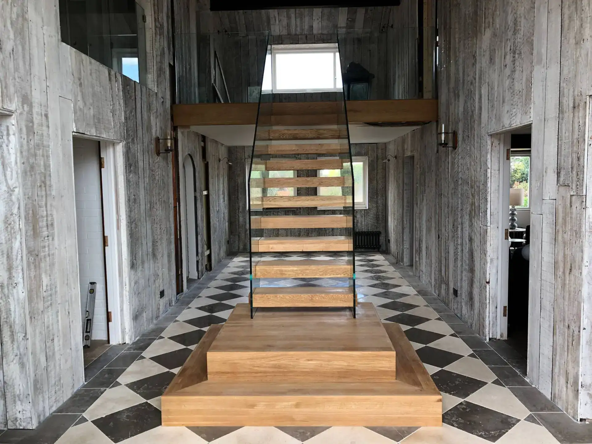 Cantilever stair turning at a half-landing with glass panels