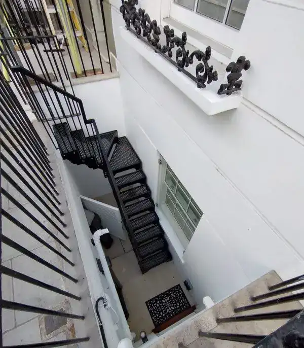 Galvanised external access stairs to first-floor balcony