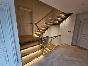 Powder-coated steel spine with slim glass balustrade fixings