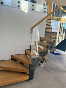 Cut-string staircase with exposed tread ends and decorative brackets