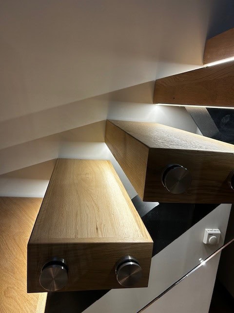 Elegant wooden staircase with integrated lighting for stylish home interiors.